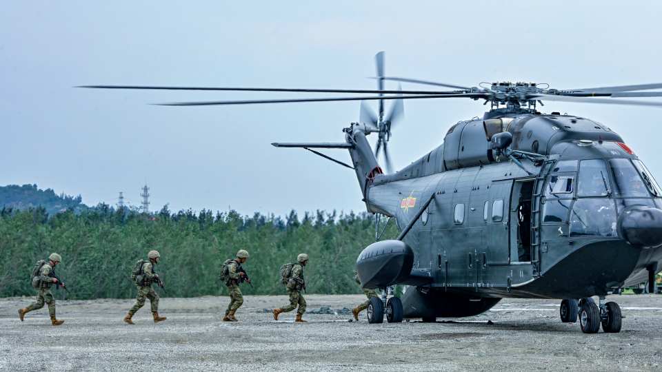 Helicopters conduct multi-subject flight training over the sea
