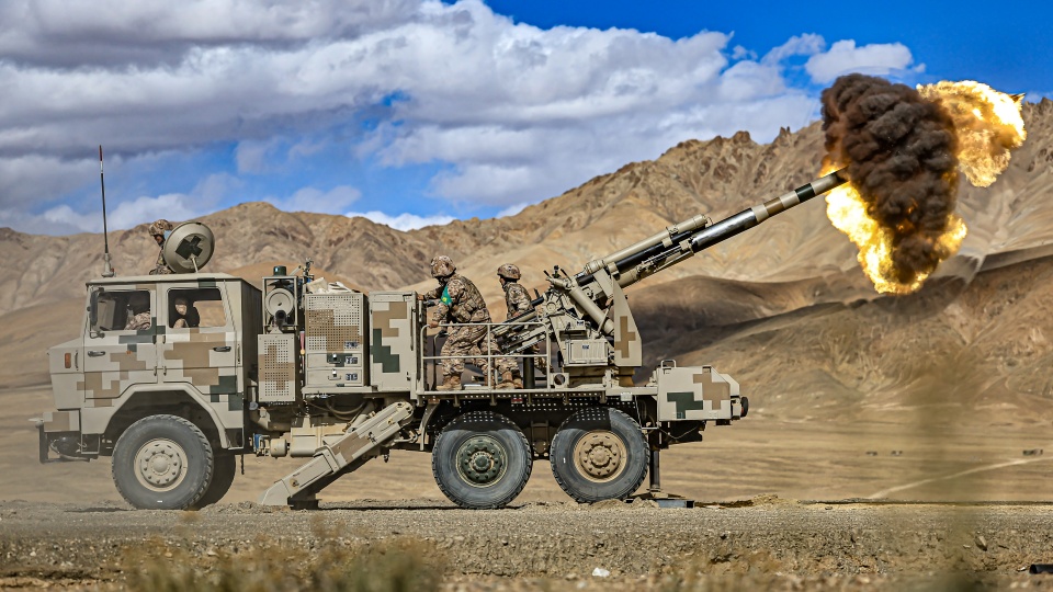 Wheeled self-propelled howitzers spit fire at targets