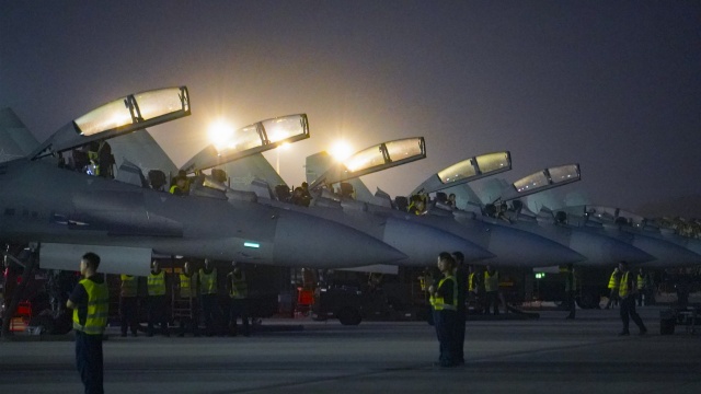 Maintenance men conduct pre-flight inspections