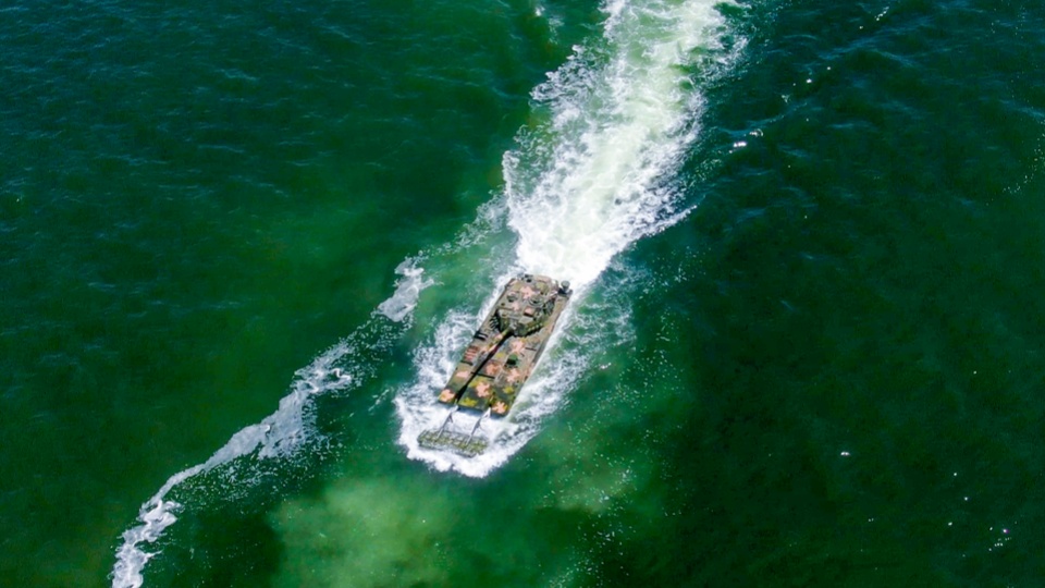 Amphibious armored vehicles maneuver in formation