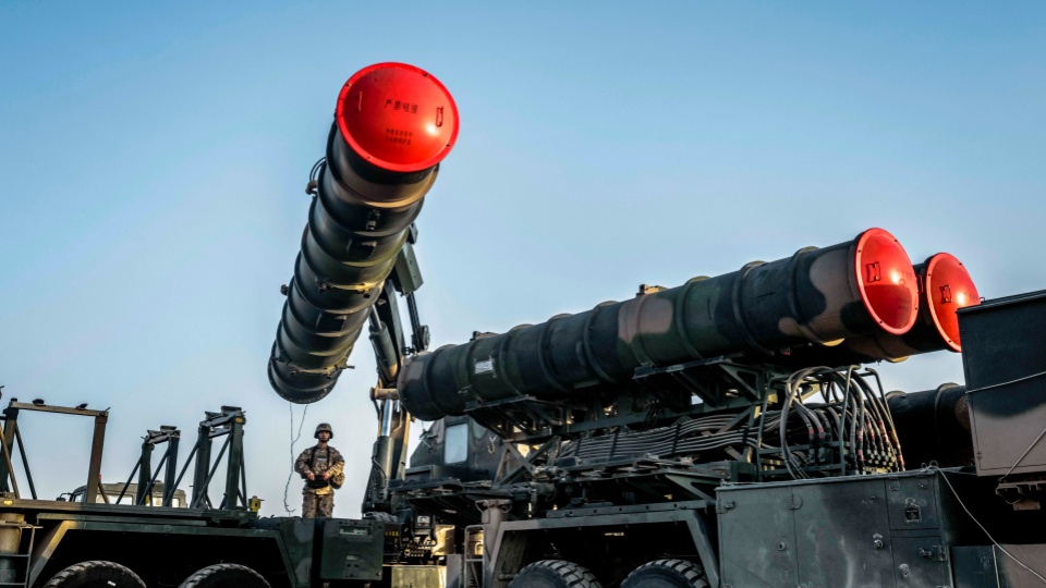 Soldiers hoist and load HQ-9 surface-to-air missile system