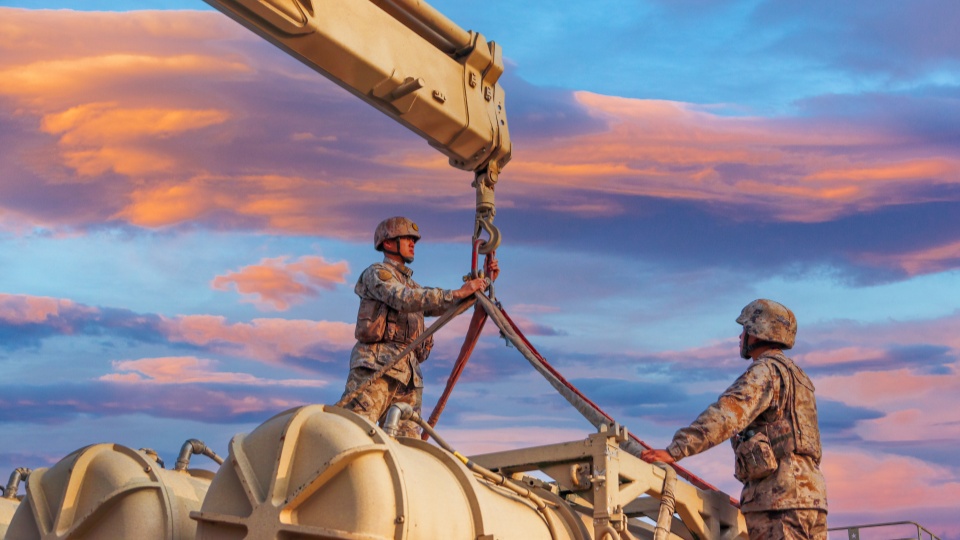 Soldiers hoist and load HQ-16 air defense missile system 