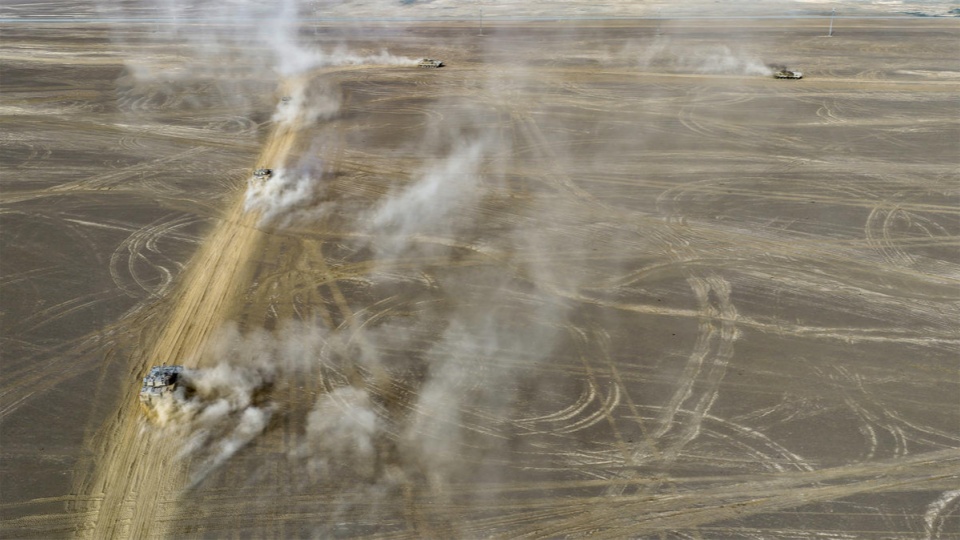 Armored vehicles en route to designated training area