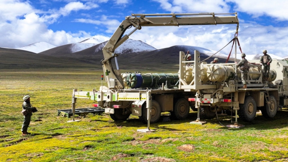 Soldiers hoist and load HQ-16 air defense missiles