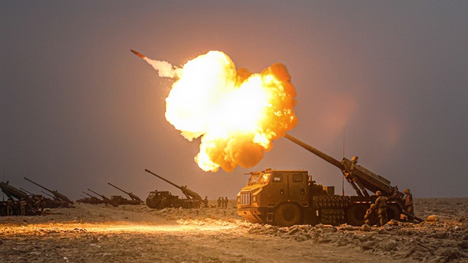 Howitzers spit fire in desert  