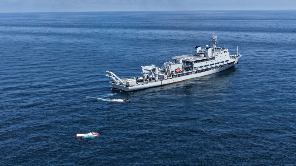 Submarine support ship sails at sea