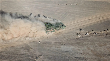 Artillerymen drive new-type amphibious armored vehicles in desert