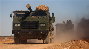 Military trucks pass through simulated infected area