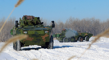 Infantry Fighting Vehicles race across snowy terrain