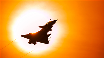 J-10 fighter jet flies past sun