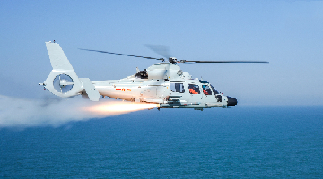 Ship-borne helicopter fires missile at mock target