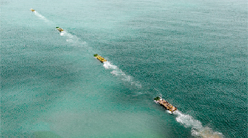 Amphibious IFVs maneuver at sea