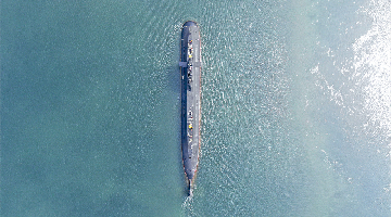 Submarine steams at sea