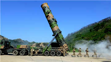 Soldiers erect DF-21A medium-range ballistic missile system