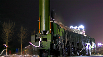 Soldiers erect ballistic missile system at night