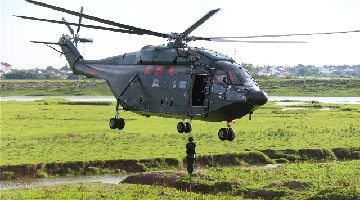 Soldiers participate in fast-rope training with helicopter