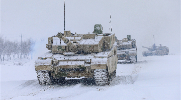 Main battle tanks rumble in snow-covered area