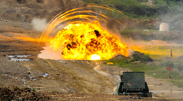 Mine-clearing vehicle fires line charge 