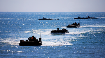 Amphibious armored vehicles conduct waterborne operations