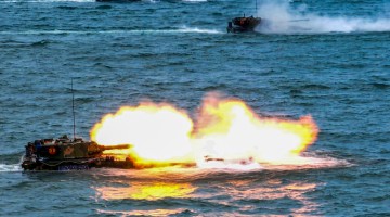 Amphibious assault vehicles open fire at sea 
