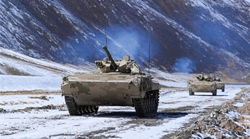 Armored vehicles in maneuver training exercise