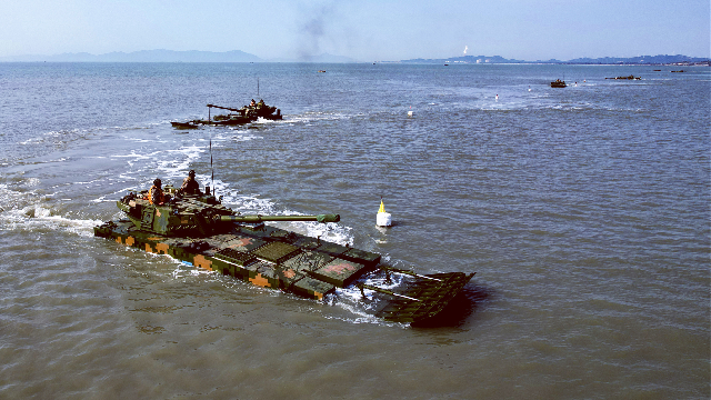 Amphibious armored vehicles maneuver in formation