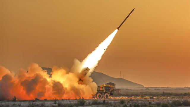 Long-range multiple rocket launcher systems fire at mock targets