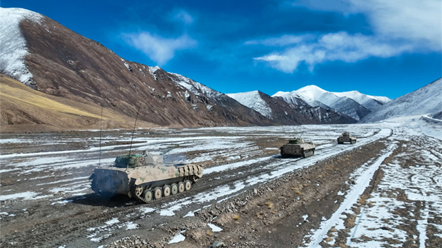 Armored vehicles in maneuver training exercise