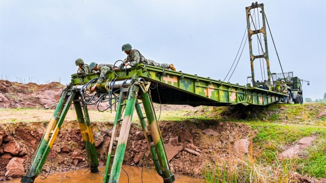 Soldiers build mechanized bridge