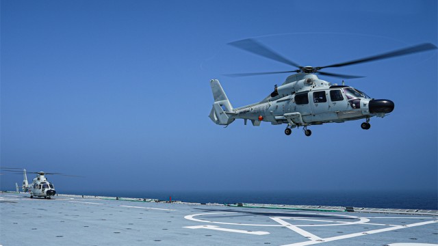 Chopper lifts off from landing ship