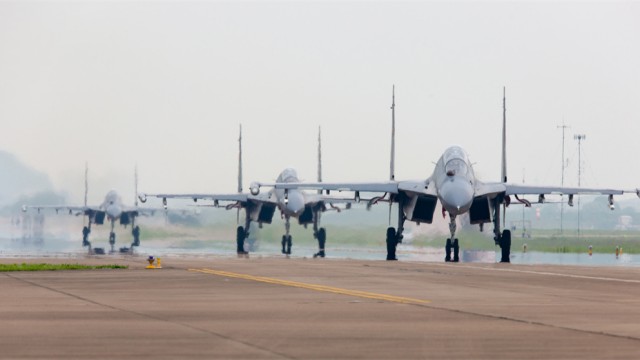 Fighter jets taxi on flight line before takeoff