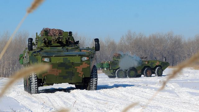 Infantry Fighting Vehicles race across snowy terrain