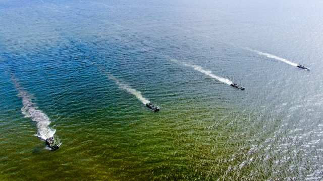 Amphibious armored vehicles maneuver in formation 