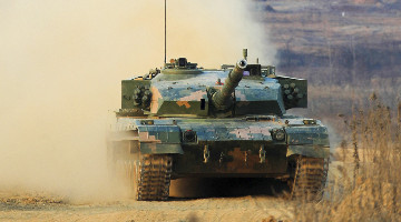 Main battle tank rumbles through mounds of dust