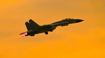 Fighter jet takes off at sunset