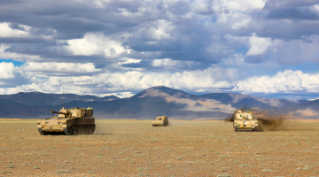 Armored vehicles maneuver in speed