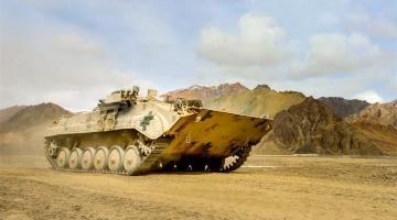 Armored vehicles engage in maneuver training