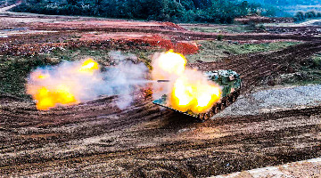 Amphibious armored vehicle fires at simulated targets
