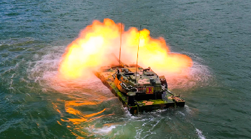 Amphibious tank fires at sea