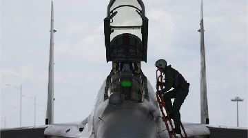 Pilot climbs into cockpit of J-16 fighter jet