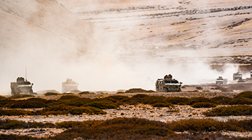 Military vehicles march in the field