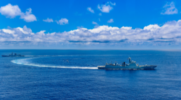 Naval vessels sail in formation