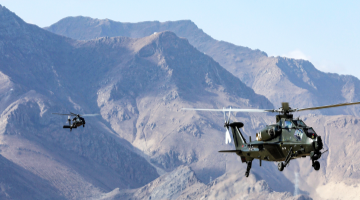 Multi-type helicopters fly through valley