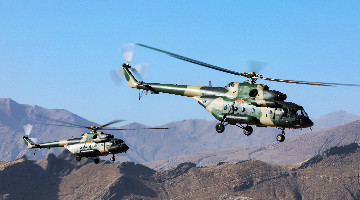 Choppers fly over mountains