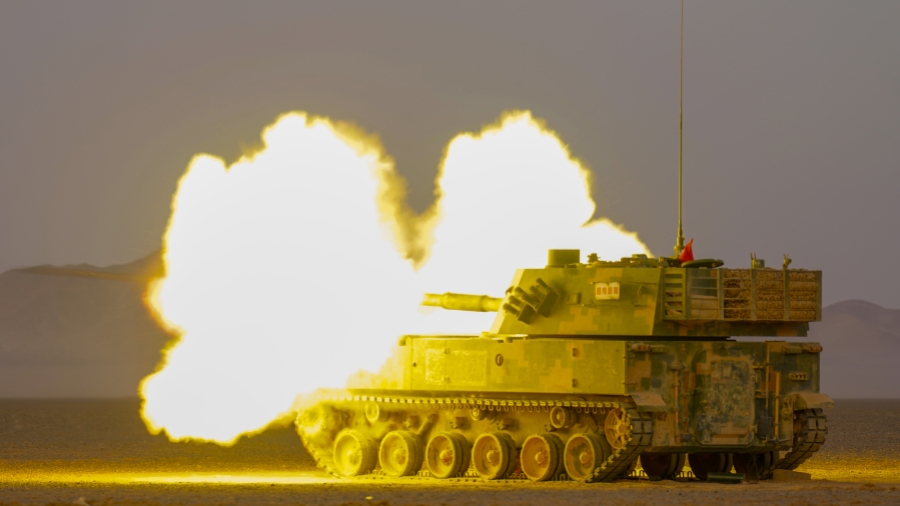 Self-propelled howitzer systems fire at targets