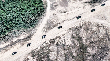 Self-propelled howitzer systems maneuver to designated area