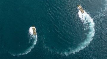 Amphibious infantry fighting vehicles steam in formation