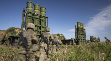 Soldiers rush toward missile launching vehicles