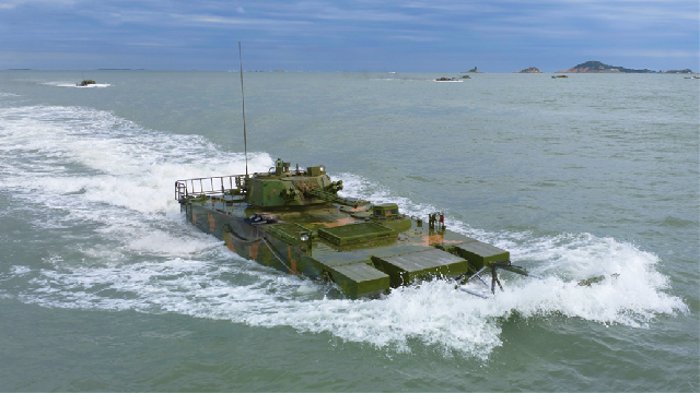 Amphibious infantry fighting vehicles (IFVs) steam in formation