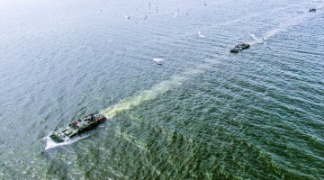 Amphibious armored vehicles maneuver in formation 